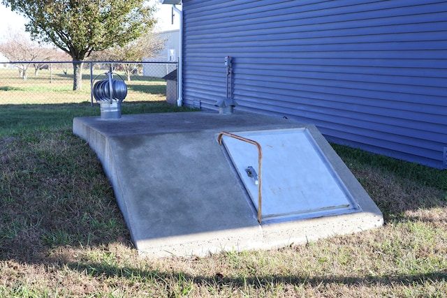 view of storm shelter featuring a lawn