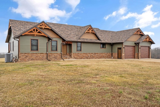 craftsman-style house featuring cooling unit, a garage, and a front yard