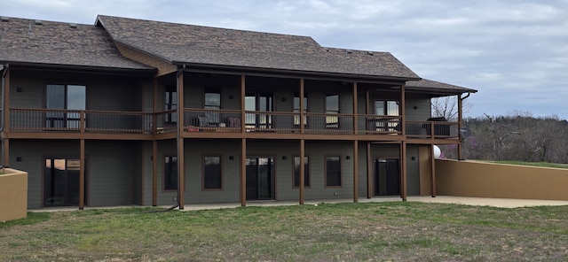 rear view of property featuring a yard and a patio
