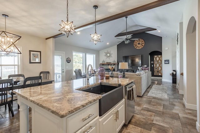 kitchen with decorative light fixtures, dishwasher, lofted ceiling with beams, arched walkways, and a sink