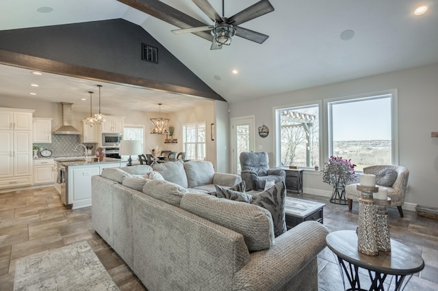 living area with baseboards, plenty of natural light, and lofted ceiling