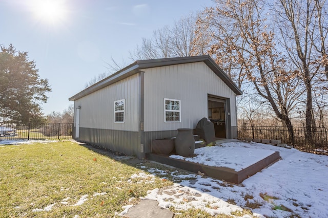 exterior space featuring a yard, a detached garage, and fence