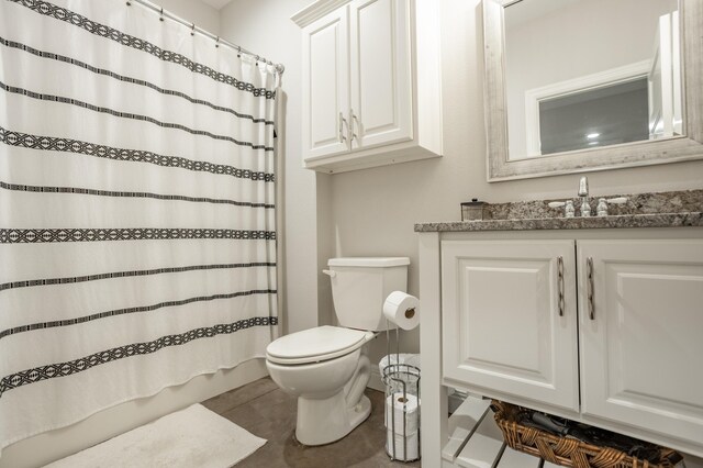 bathroom featuring a shower with shower curtain, tile patterned floors, toilet, and vanity