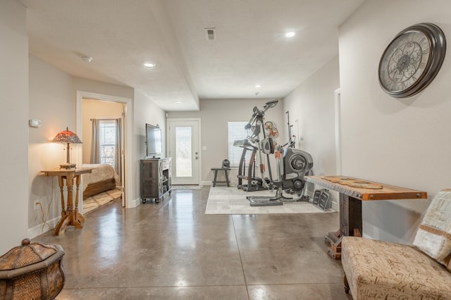 exercise area with recessed lighting, plenty of natural light, baseboards, and visible vents