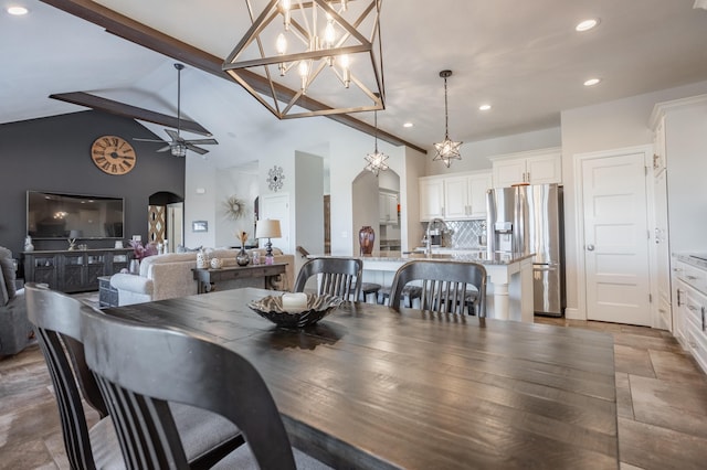 dining space with arched walkways, beamed ceiling, recessed lighting, and ceiling fan