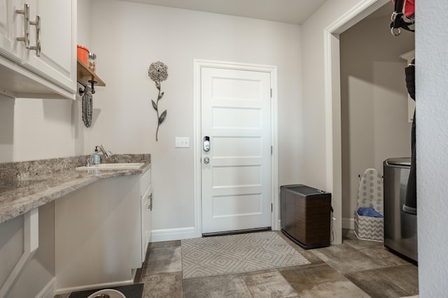 interior space with baseboards and a sink