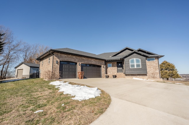 view of front facade featuring brick siding, an attached garage, driveway, and a front lawn