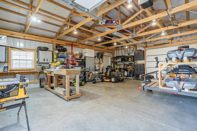 garage featuring a workshop area, metal wall, and a garage door opener