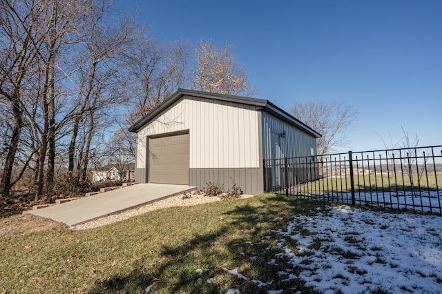 detached garage with fence and driveway