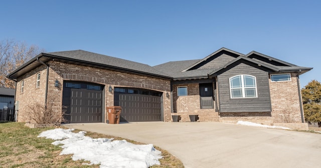 craftsman-style home with an attached garage, brick siding, and driveway