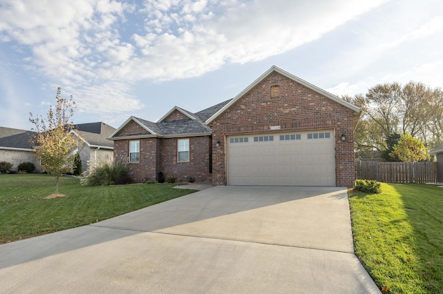 view of front of house featuring a front yard and a garage