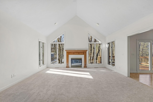 unfurnished living room featuring light colored carpet and lofted ceiling