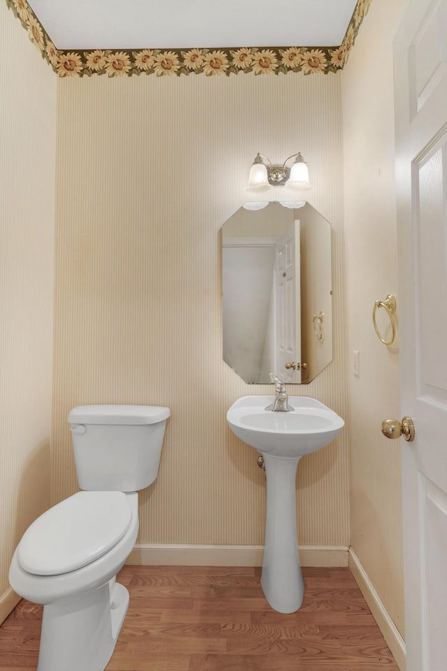 bathroom featuring hardwood / wood-style flooring and toilet