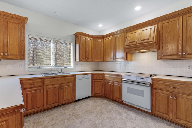 kitchen featuring premium range hood, white appliances, sink, and decorative backsplash