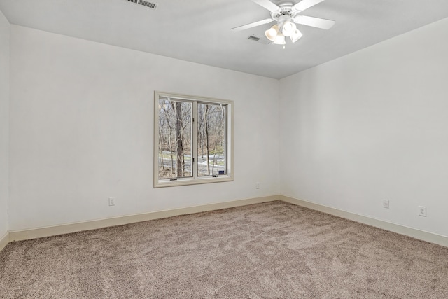 unfurnished room with ceiling fan and carpet flooring