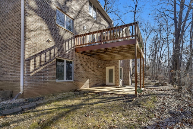 rear view of property with a wooden deck and a patio area