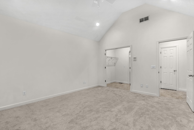 unfurnished room featuring ceiling fan, high vaulted ceiling, and light carpet