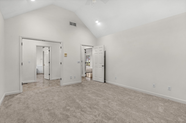 unfurnished bedroom featuring light carpet, high vaulted ceiling, and ceiling fan