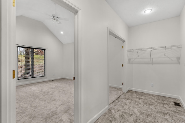 interior space with high vaulted ceiling, light colored carpet, and ceiling fan