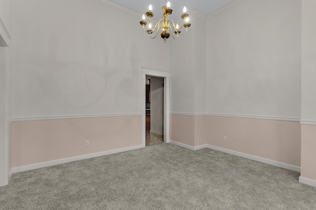 carpeted empty room with a notable chandelier, crown molding, and a high ceiling