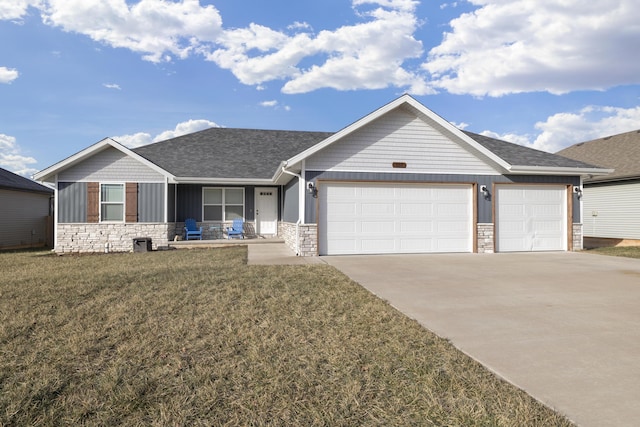 view of front of house featuring a garage and a front lawn