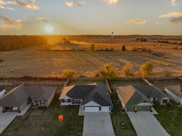 aerial view at dusk featuring a rural view