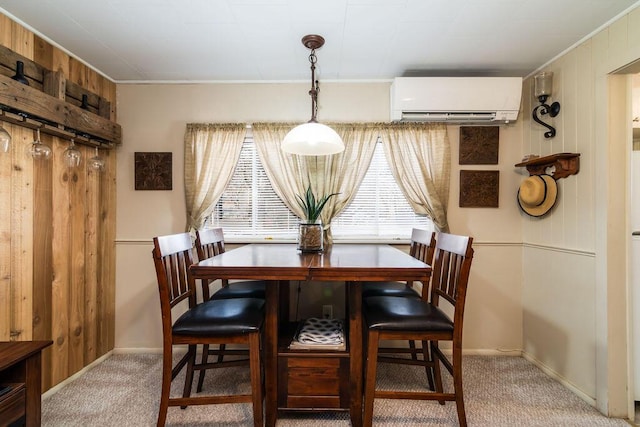 dining space with carpet floors, a wall unit AC, and wooden walls