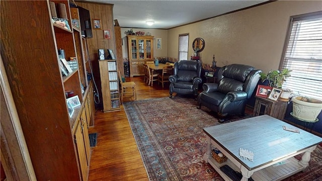 living room with dark hardwood / wood-style flooring and ornamental molding