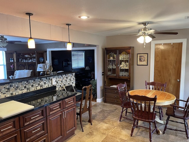 kitchen with decorative light fixtures, backsplash, and ceiling fan