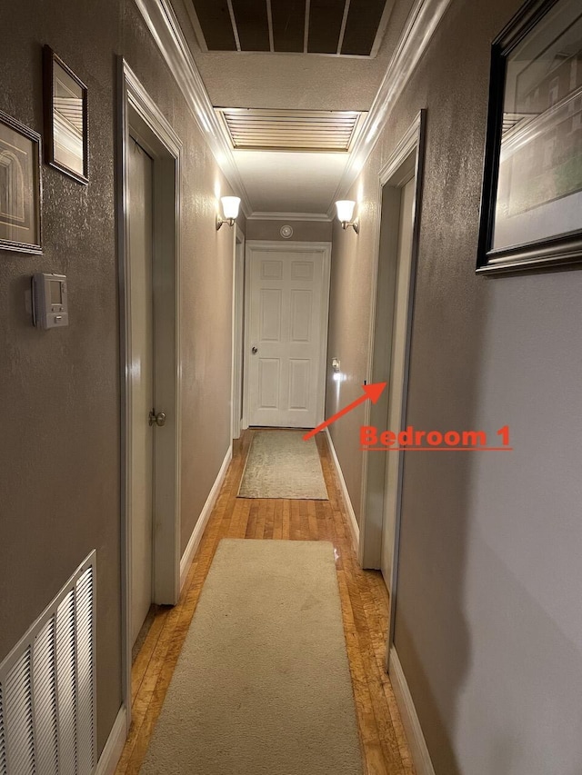 hallway featuring light wood-type flooring and crown molding