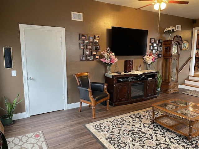 living room featuring ceiling fan and wood-type flooring