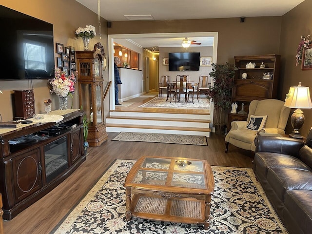 living room with ceiling fan and dark hardwood / wood-style flooring