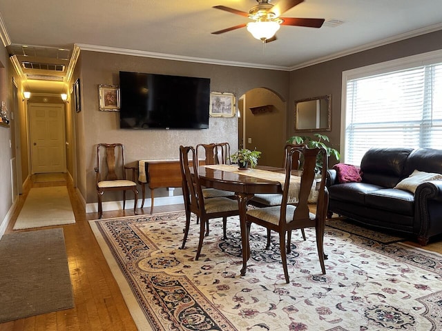 dining space with ceiling fan, ornamental molding, and hardwood / wood-style floors