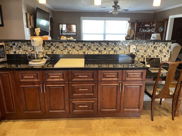 kitchen with ceiling fan, light tile patterned floors, crown molding, and tasteful backsplash