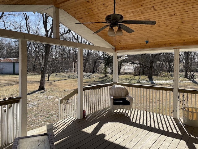 wooden deck featuring grilling area and ceiling fan