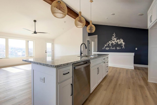 kitchen with light stone counters, stainless steel dishwasher, white cabinetry, a sink, and light wood-type flooring