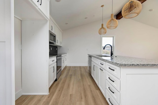 kitchen featuring light stone counters, stainless steel appliances, a sink, light wood-style floors, and tasteful backsplash