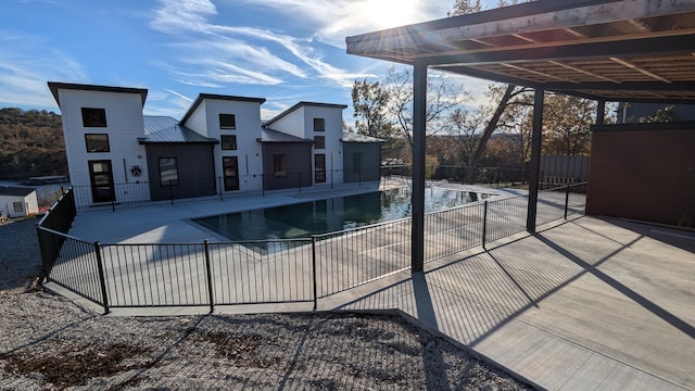 view of swimming pool featuring a patio area, fence, and a fenced in pool