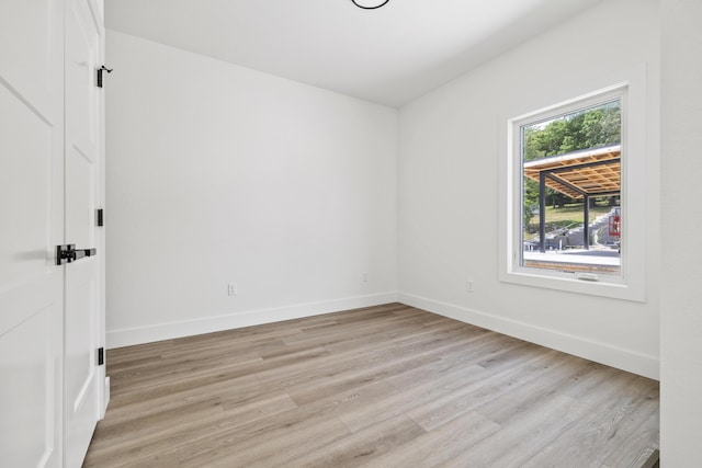 empty room with light hardwood / wood-style flooring