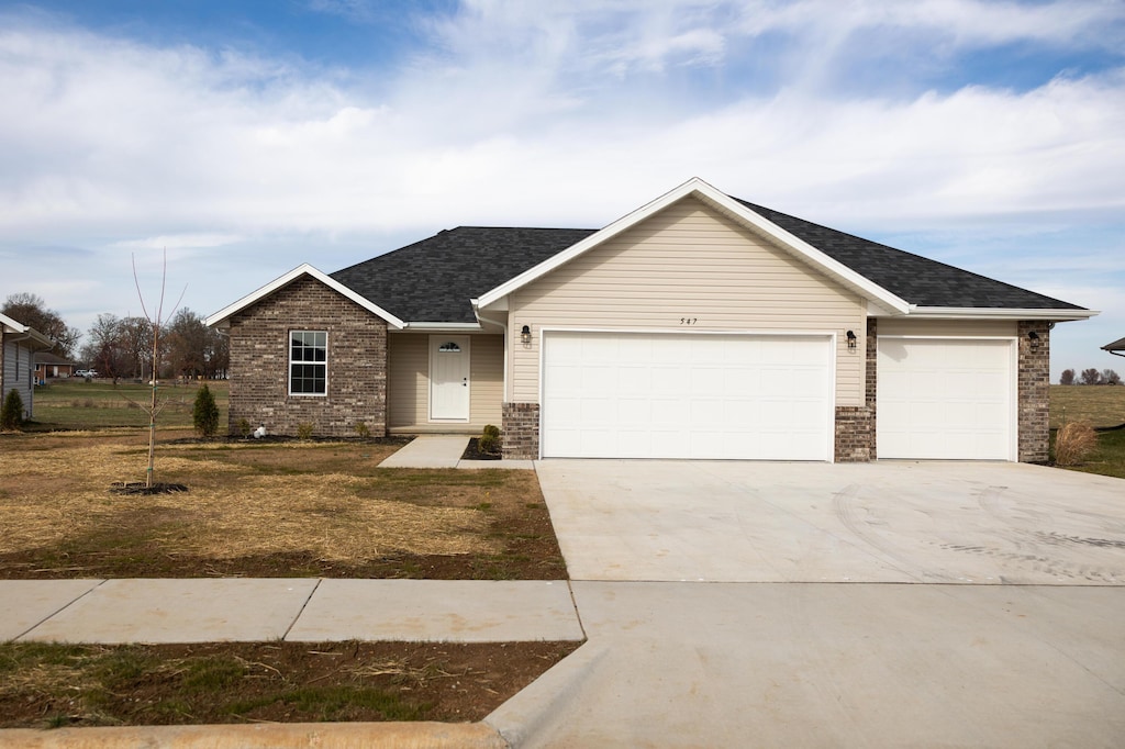 ranch-style home featuring a front yard and a garage