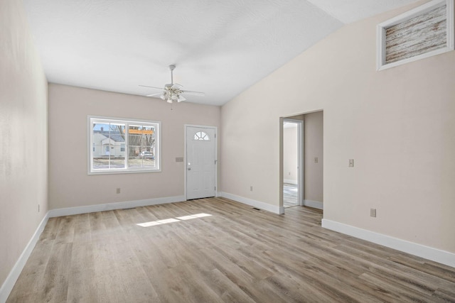 interior space featuring ceiling fan, vaulted ceiling, and light hardwood / wood-style flooring