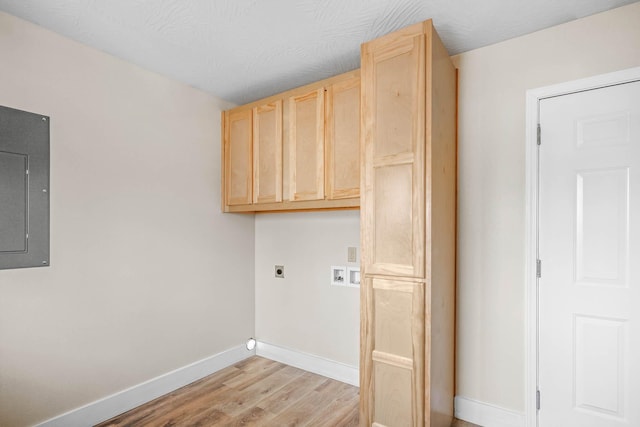 laundry room with hookup for an electric dryer, washer hookup, cabinets, electric panel, and light hardwood / wood-style flooring