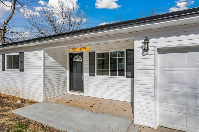 view of exterior entry with a garage