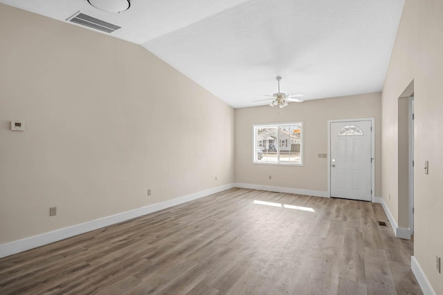 interior space with hardwood / wood-style flooring, lofted ceiling, and ceiling fan