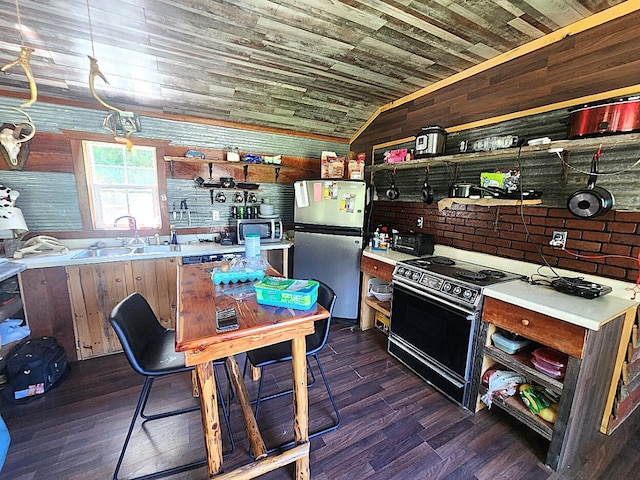 kitchen featuring electric stove, wood walls, sink, wood ceiling, and stainless steel fridge