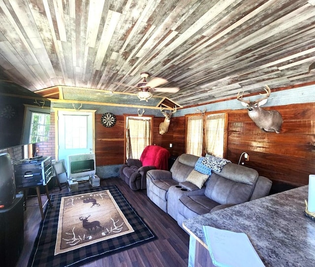 living room featuring crown molding, wooden walls, heating unit, dark hardwood / wood-style flooring, and wooden ceiling