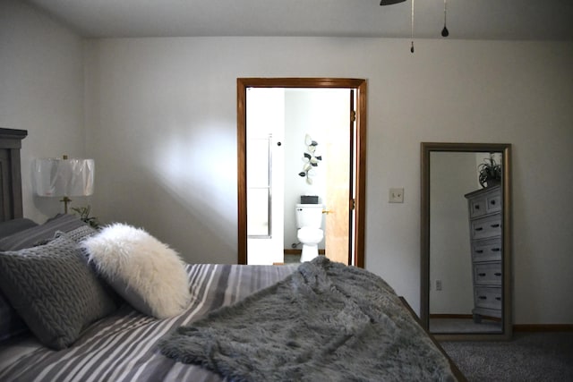 bedroom featuring ensuite bath and carpet flooring