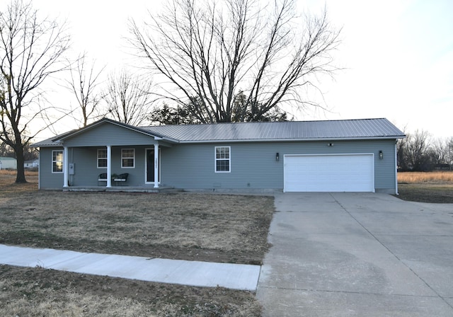 single story home featuring covered porch and a garage