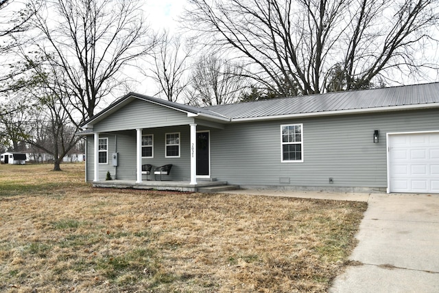 ranch-style home with a garage, a front yard, and a porch