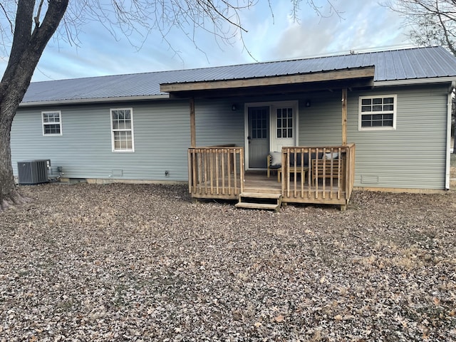 rear view of property featuring a deck and central AC unit